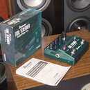 Zelený kytarový efekt pedál s nápisy TUBE SCREAMER Overdrive Pro a Ibanez. Vedle pedálu je umístěna modrá krabice s identickými nápisy a modelovým oz…