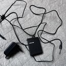 Černý napájecí adaptér s kabelenmi a malým černým boxem. Na boxu je bílý nápis NUX. Kabel končí standardním 6,3mm jack konektorem.