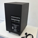 Černý aktivní subwoofer s matným povrchem. Na zadním panelu jsou ovládací prvky a konektory s nápisy ADAM AUDIO Germany-Berlin, Active Subwoofer a mo…