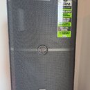 Černý reproduktor s kovovou mřížkou. Na horní části je nalepený štítek s nápisy SRM V-CLASS, SERIOUS OUTPUT 1000W OF SOLID POWER, CUTTING-EDGE TECHNO…
