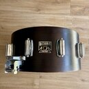 Tmavně hnědý dřevěný korpus bubnu s chromovaným kováním. Uprostřed je umístěn štít s nápisy TAMA, SUPERSTAR a dále No. 13 x 8 MADE IN JAPAN. Povrch k…