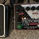 Na fotografii jsou dva kytarové pedály. Vlevo je stříbrný pedal s černým vrchem a nápisem 3ECN. Vpravo je efekt Electro-Harmonix Deluxe Memory Boy an…