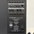 Zadní panel černého aktivního subwooferu značky ADAM AUDIO Germany Berlin. V horní části jsou ovládací prvky s nápisy MODE, SUBWOOFER PHASE (180°, 0°…