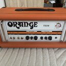 Kytarový kombozesilovač v oranžovém texturovaném potahu s černou rukojetí. Na bílém předním panelu je velký nápis ORANGE a označení modelu TH30. Pane…