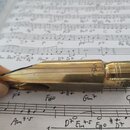 Zlatý kovový mouthpiece s černým plátkem a ligaturem. Na těle je vyryta hvězda a pod ní číslice 7, na ligatureře je viditelné logo R. Povrch vykazuje…