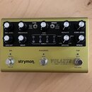 Zlatý efekt pedál s nápisy strymon, VOLANTE a Magnetic Echo Machine. Zařízení má osm černých otočných ovladačů, tři kovové spínače a čtyři kontrolní…