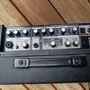 Černý kytarový zesilovač s nápisem CUBE Street a COSM AMPLIFIER. Horní panel obsahuje ovládací prvky pro MIC/LINE CHANNEL a GUITAR/INSTRUMENT CHANNEL…