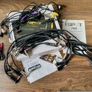 Fotografie zobrazuje napájecí zdroj 1SPOT PRO CS12 s doprovodnými kabely, manuálem a dokumentací. Na krabici i v manuálu je uveden nápis 1SPOT PRO a…