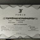 Fotografie znázorňuje certifikát pravosti (Certificate of Authenticity) značky FURCH. Dokument obsahuje logo ve tvaru stylizovaného písmene F a texty…