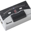 Stříbrný digitální ladič s černým ovládacím panelem a gumovým pedálem. Na přístroji jsou viditelné nápisy Ibanez, DIGITAL TUNER LU20 a ovládací tlačí…