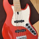 Kytara typu basová s červeným lakovaným tělem a světlým hnedem hрифem. Má bílý vzorovaný pickguard, dva snímače a čtyři ovládací knoflíky na kovové p…