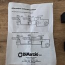 Fotografie znázorňuje bílý papírový leták s názvem „Alternative wiring possibilities“. Dokument obsahuje dva technické schémata zapojení elektroniky…