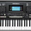 Černý digitální klavír značky KURZWEIL, model KP380X. Nástroj má vestavěné reproduktory po obou stranách a centrální ovládací panel s displejem, na k…
