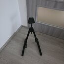 Černý kovový stativ s trojnožkou a horní plochou opěrkou. Povrch je matně černý, bez viditelných značek, log nebo nápisů. Stav vypadá na první pohled…