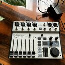 Bílý digitální mixér s nápisem FLOW 8 Bluetooth Controlled Digital Mixer. Na horním panelu je logo behringer a označení F. Zařízení obsahuje osm posu…