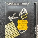 Černá krabička s nápisy KAWAII CARD ROM. Uprostřed je bílý stylizovaný nápis KA a označení A4-01 analog. Na povrchu jsou dvě žluté cenovky s přeškrtn…