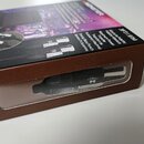 Hnědá kartonová krabice s produktem uvnitř, viditelným přes plastové okénko. Na krabici jsou nápisy Absolute Fidelity, Fidélité Absolue, Maximum Powe…
