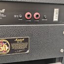 Zadní panel kytarového zesilovače značky Marshall s nápisem Model: JMP1C. Panel obsahuje dva červené výstupní konektory označené 1 x 16 OHM a 1 x 8 O…