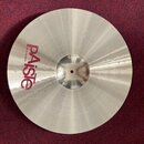 Stříbrný kovový činel s viditelným broušením povrchu. Na ploše je červený nápis Paiste a pod ním menší text MADE IN SWITZERLAND. Povrch je čistý bez…