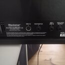 Detail zadní části černého kytarového komba. Je zde vidět logo Blackstar a nápis Designed and Engineered by Blackstar Amplification Ltd Northampton,…