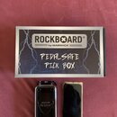 Fotografie zobrazuje krabičku na trsátka a její originální obal. Na kartonové krabici je nápis ROCKBOARD® by WARWICK a ručně napsaný text PEDALSAFE P…