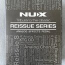 Krabice efektového pedálu značky NUX z řady REISSUE SERIES. Na přední straně je bílý nápis NUX a text Tribute to the classic ANALOG EFFECTS PEDAL. Po…