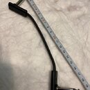 Černý audio kabel s konektory typu jack na obou koncích. Na plastovém krytu jednoho z konektorů je vyražen nápis ROCKGUARD. Vedle kabelu je přiložen…