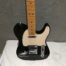 Černá elektrická kytara typu Telecaster s bílým pickguardem a hnědým javorovým hmatníkem. Na spodní části těla je bílý nápis „EarthQuaker Devices“ do…
