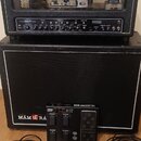 Černý kytarový zesilovač Line 6 Spider IV HD umístěný na černé reproduktorové skříni. Na předním panelu zesilovače jsou viditelné ovládací prvky a ná…