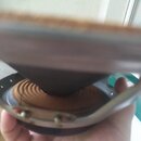 Fotografie zachycuje detail reproduktoru z pohledu zezadu. Je vidět hnědý papírový kužel, kovový rám a magnet v dolní části. Na komponentu nejsou vid…