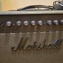 Kytarový kombo zesilovač značky Marshall. Na ovládacím panelu je nápis DSL 40C a řada stříbrných otočných knoflíků s popisky jako VOLUME, Classic Gai…