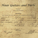 Fotografie certifikátu od Haar Guitars and Parts s ručně vyplněnými specifikacemi kytary. Je zde uveden model classic S, tělo z Alder v provedení lig…