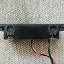 Černý obdélníkový modul s dvěma otočnými potenciometry. Pod levým knoflíkem je nápis Master a pod pravým nápis MIC. Ze spodní strany vedou červené a…