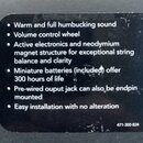 Fotografie detailu černé štítku s bílým textem v angličtině. Text obsahuje seznam vlastností produktu, včetně nápisů „Warm and full humbucking sound“…
