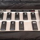 Stříbrný MIDI kontrolér s černými spínacími pedály a dvěma expresními pedagogy. Na horní části je nápis FCB1010 MIDI FOOT CONTROLLER a sekce PRESET C…