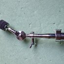 Kromě části stojanu je na fotografii vidět mikrofonní držák s černou pěnovou čelnicí. Celý mechanismus je vyroben z chromovaného kovu. Na povrchu nej…