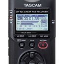 Černý digitální nahrávač s nápisem TASCAM a označením DR-40X LINEAR PCM RECORDER. Zařízení má LCD displej s běžícím časem a dvěma XLR konektory v hor…