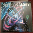 Fotografie zobrazuje obal vinylové desky s nápisem CRIMSON GLORY v horní části a TRANSCENDENCE v dolní části. Na obalu je surrealistický obraz ženské…