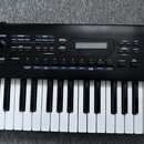 Černý digitální klavír s ovládacím panelem a bílo-černými klávesami. Na panelu jsou viditelné nápisy VOLUME, MODE (PATCH, PERFORM, DEMO), EDIT (PARAM…