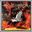 Fotografie zobrazuje obal CD nebo vinylu s nápisem THE MISSION a pod ním menším písmem Carved in Sand. V dopřední části je bílý pták v letu nad písko…
