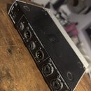 Zadní strana černého elektronického zařízení s bílým šasi. Jsou zde viditelné nápisy „BLUETUBE“, „BALANCED / UNBALANCED OUTPUTS“ u dvou výstupů XLR a…
