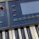 Detailní záběr na ovládací panel a klávesy černého elektronického klavíru. Na levé straně je sekce SOUND MODIFY s pěti červenými otočnými ovladači a…