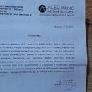 Fotografie zobrazuje papírový dokument s nadpisem GWARANCJA. V horní části je logo a název ALEC music ATELIER FLETOWE spolu s kontaktními údaji pro A…
