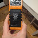 Kartonová krabička oranžové a černé barvy s nápisem Tube Amp Doctor™ a SELECTED TUBES PREMIUM QUALITY. Na černé části je seznam testů, kterými elektr…