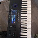 Černý MIDI kontrolér s klaviaturaí a displejem. Na spodní části je viditelný nápis NTROL S49 N. Zařízení obsahuje modře podsvícený otočný ovladač, ně…
