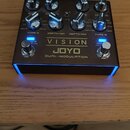 Kytarový efekt pedál v kovovém šasi s nápisy VISION, JOYO a DUAL-MODULATION. Horní panel obsahuje osm kovových otočných knoflíků s označením SPEED, C…