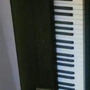 Černý elektronický klavír s bílými a černými klávesami. Na horní části je viditelný nápis KORG. V dolní části se nachází malý displej.