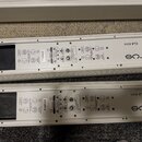 Dvě bílé lineární reproduktory značky FBT, model VERTUS CLA 604A. Na zadní stranách jsou viditelné ovládací prvky, konektory pro napájení a signál a…