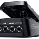 Černý kytarový pedál s otevřeným horním krytem. Na zadní straně jsou čtyři konektory s nápisy INPUT, EXP, TUNER a OUTPUT. Na boku je bílé logo Dunlop…