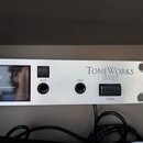 Stříbrný rackový přístroj s nápisy TONEWORKS a KORG. Na předním panelu jsou umístěny dva přepínače s popisky MUTE a POWER, vstupní konektor INPUT a d…